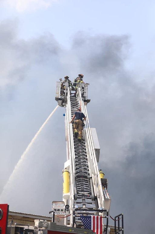 firemen on ladder in smoke
