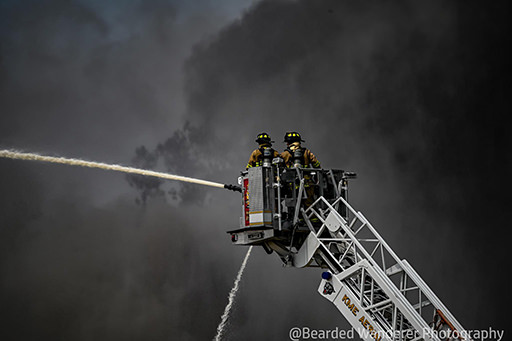 firemen spraying fire in smoke